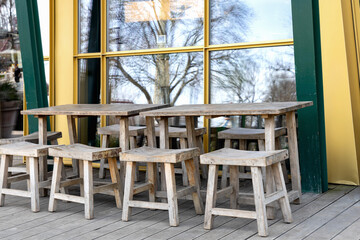 Wooden tables and chairs on the veranda.