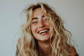 Radiant Smile, Joyful Blonde Woman Laughing Heartily on Neutral Background