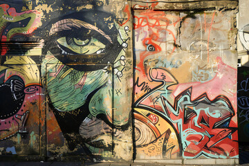 Fototapeta premium Colored graphite on a wall in the city, graphite in the form of eyes 