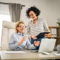 Two mature woman work and consult at office