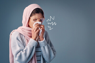 Flu, sick and woman with hijab in studio with toilet paper allergies and runny nose. Muslim female...