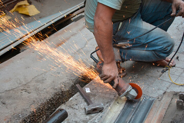 Man cutting Galvanized Iron Rolling Shutter Strip
