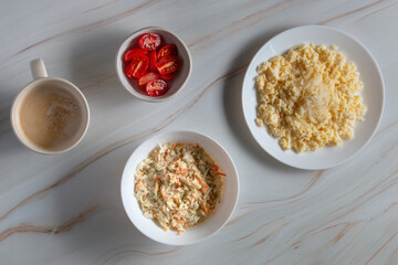 Light empty plates without food on light marble background, flat lay, top view.