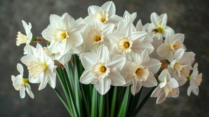   White daffodils in a green vase on a gray tablecloth against a black background