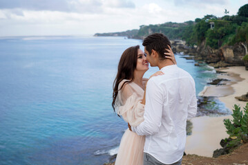 Embracing on the shore, a couple celebrates their wedding