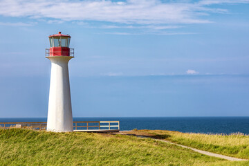 Borgot, or Cape Herisse lighthouse of Cap aux Meules, Magdalen Islands, Canada. The lighthouse stands on the rugged red cliffs of the Etang du Nord.