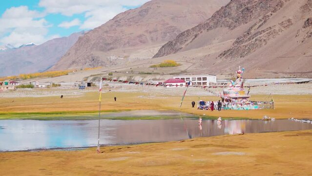 Landscape shot of statue of Guru Padmasambhava in front of the Himalayan mountains at Sani lake near Padum in Zanskar Valley, Ladakh, India. Statue of Buddha in front of the mountains.