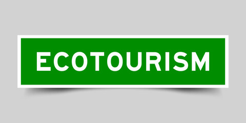 Green color square label sticker with word ecotourism that inserted in gray background