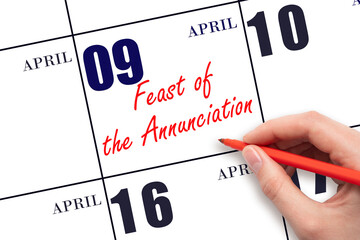 April 9. Hand writing text Feast of the Annunciation on calendar date. Save the date.