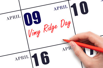 April 9. Hand writing text Vimy Ridge Day on calendar date. Save the date.