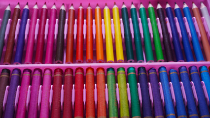 Neatly organized group of colorful pencils and color pastels for education template background. Selective focus                              