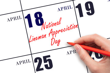 April 18. Hand writing text National Lineman Appreciation Day on calendar date. Save the date.