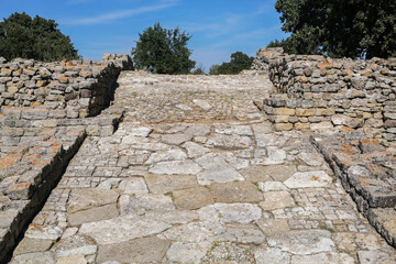 Ancient troy (Troja). Southwest ramp of Troy II - the main entrance to citadel of ancient Troy. Hisarlik hill. Tevfikiye (Cankkale), Turkey (Turkiye) - obrazy, fototapety, plakaty
