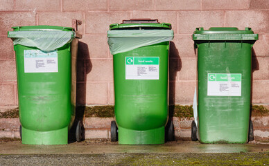 Wheelie bins in row segregated for recycling rubbish - obrazy, fototapety, plakaty