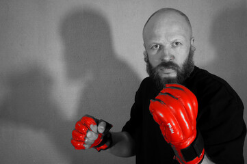 Boxer in red boxing gloves. Athlete, bodybuilder, athlete, muscle, sport, mma, fight, danger.                            Pugilist, mauler, pug, sparrer, prize-fighter