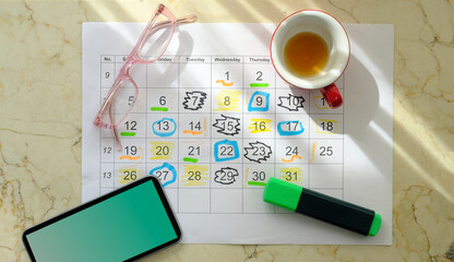 Calendar with business appointments,pens,coffee cup and spectacles, monthly schedule. Business concept,beat the clock.