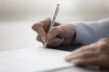 Unknown female hand holding pen and signing legal contract agreement, buying or selling services,...