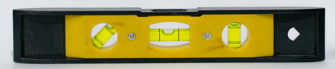 Black and yellow level with three white dots on the front, on an isolated background, which can be...