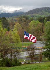 Large American flag in the foreground of the Smokey Mountains