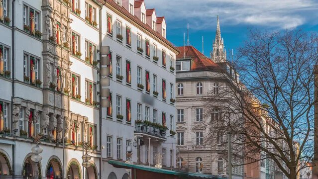 Kaufingerstrasse, shopping street and pedestrian zone in Munich downtown near the Marienplatz timelapse. Evening light on historic buildings with people walking around. Bavaria, Germany