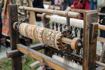 Ancient crafts historic medieval festival spinning frame with wool fabrics