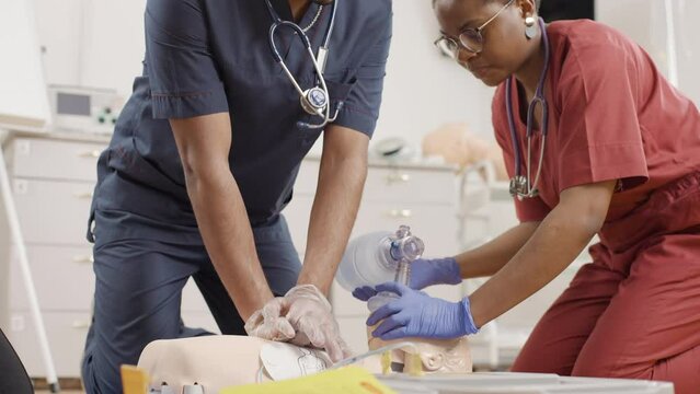 Medical procedure: practicing first aid on a mannequin