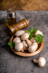 Raw white mushrooms champignons and pepper on grey background for cooking fresh ingredients. free copy space