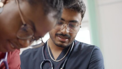 Medical professionals performing first aid procedure on mannequin