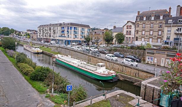 Redon, Brittany, France - September 27, 2023: Boats in the Nantes-Brest Canal, from Pont de Ville, near the Vilaine River, city center. Canals are important commercial transport in France and Europe.