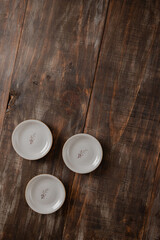 3 little vintage butter plates over dark wood boards with space for text mockup