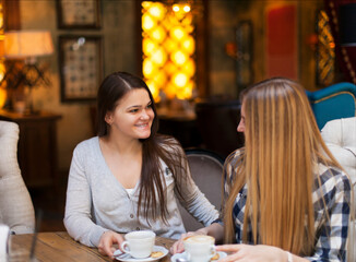 Young women drinking coffee in a cafe