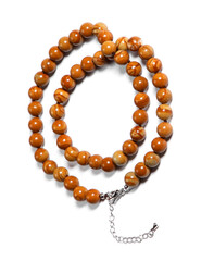 Beads made of natural brown amber on a white background.