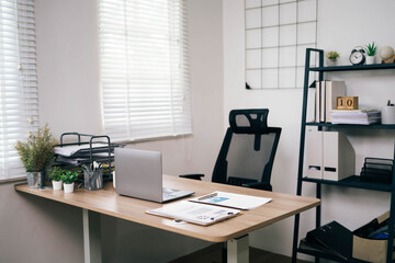 A clean and organized office with a desk, chair, and bookshelf