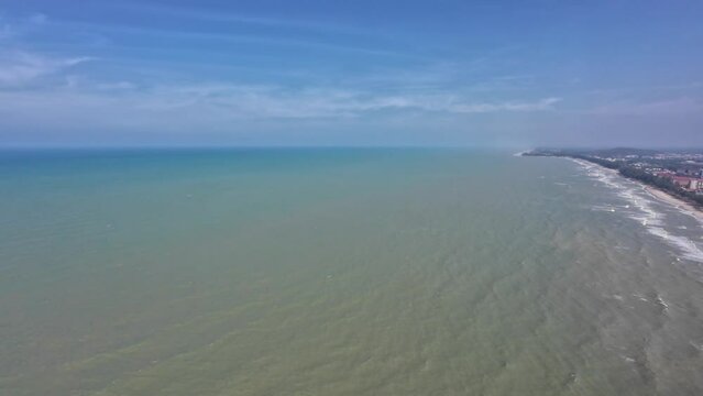 Arieal view of Songkhla Thailand while flying from the sea into a town 

