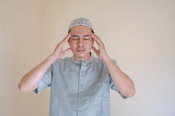 Moslem Asian man dizzy and headache face when Ramadan celebration.