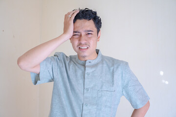 Moslem Asian man dizzy and headache face when Ramadan celebration.