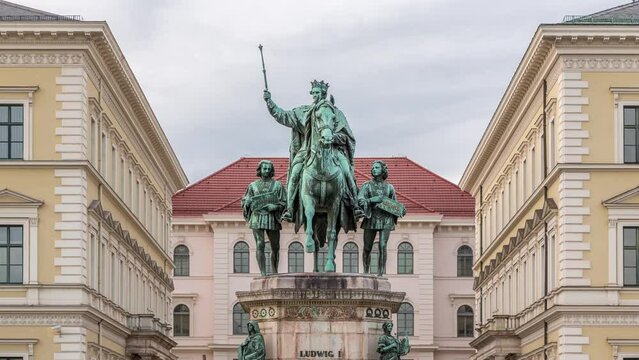 Monument Reiterdenkmal of King Ludwig I of Bavaria timelapse, which is located at the Odeosplatz in Munich, Germany. Front view with historic buildings on a background.