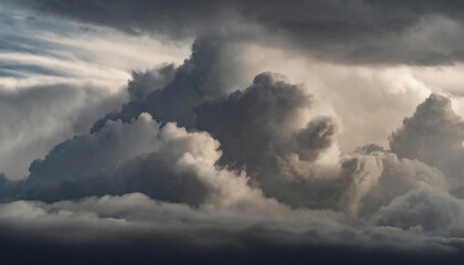 Fototapeta na wymiar Dramatic cloudscape with dark, billowing clouds illuminated by soft light.