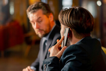 close up in office the director sits with business partner discussing a deal reading documents talking on the phone