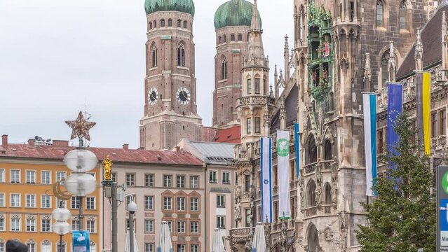 Marienplazt Old Town Square with the New Town Hall timelapse. Neues Rathaus and Town Hall Clock Tower Glockenspiel. Munich skyline, downtown cityscape near exit from the metro. Bavaria, Germany