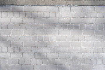 white brick wall background with slight shadows on it