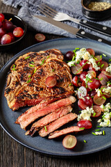 fried beef steak with salad of grape, cheese
