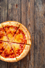 Margherita Pizza with tomato sauce and mozzarella cheese on wooden background
