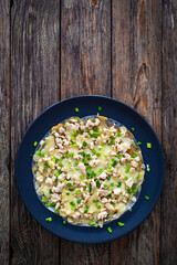 Vietnamese pizza - rice pepper omelet with chicken meat and mushrooms on wooden table
