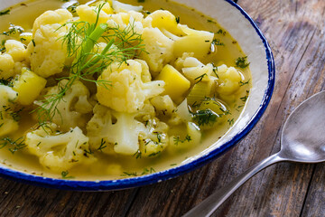 Cauliflower soup on wooden table
