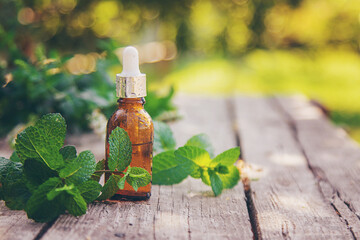 Peppermint essential oil in a bottle. selective focus.