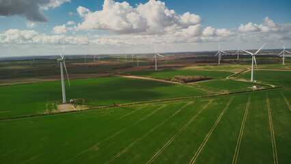 Turbine Windmills wind farm in rural England. Renewable energy. Beautiful sunny day.
