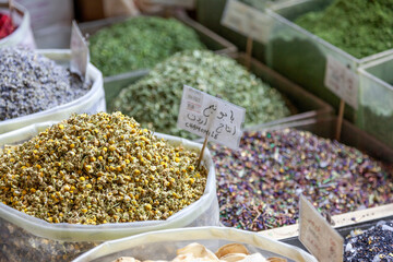 Dried traditional garments and spices at Souq Waqif in Doha, Qatar. There are chamomile, banana, rose flowers and others, many of which are product of Iran. 