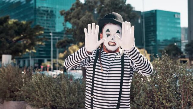 Mime, artist and man in city with paint on face for performance, action and comedy outdoor. Art, creativity and comic acting in urban street for drama or show, entertainment and mask for fun