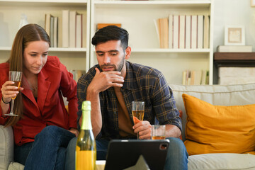 Amidst holiday decorations, a couple shares a cheerful toast with flutes of bubbly, reveling in the...